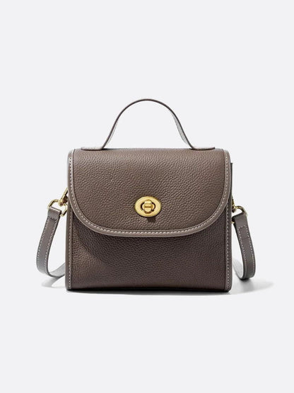 Aurora Signature Trapeze Bag – Structured Handbag with Turn-Lock Closure